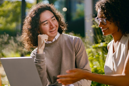 person instructing and learner reviewing strategies in natural outdoor environment with engagedの写真素材