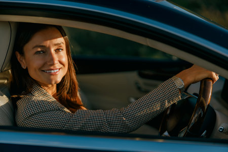Woman carefully controlling car prior to crucial business gatheringの写真素材