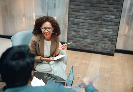 consultant reviewing papers, female counselor providing detailed guidance with attentive interactionの写真素材