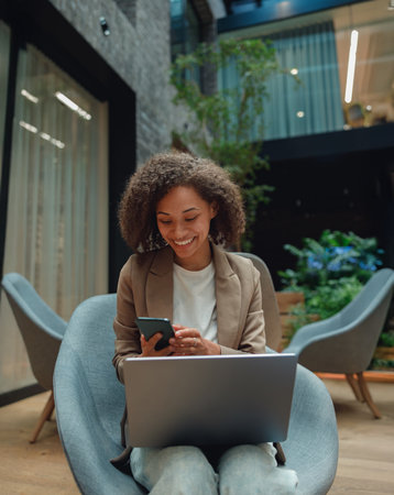 relaxed business professional, confident executive coordinating tasks in contemporary office settingの写真素材