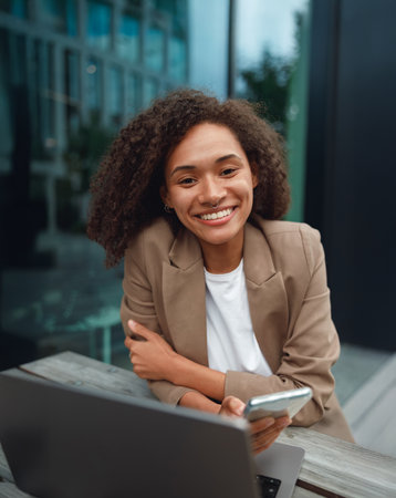 casual shot outdoors with device, authentic social media image amidst modern architecture and daylightの写真素材