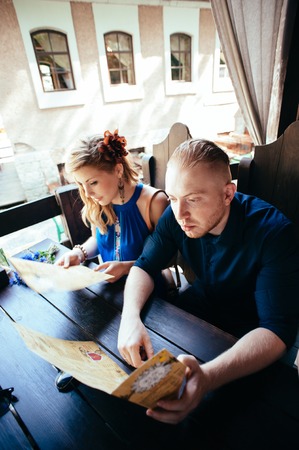 Man and woman looking at the menu in the restaurant.の写真素材