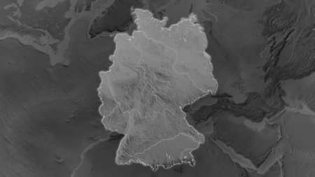 Germany area enlarged and glowed on a darkened background of its surroundings. Grayscale bumped elevation mapの写真素材