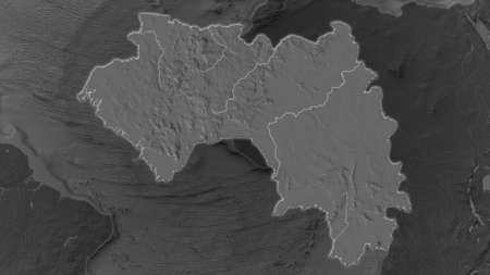 Guinea area enlarged and glowed on a darkened background of its surroundings. Bilevel bumped...