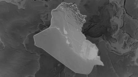 Iraq area enlarged and glowed on a darkened background of its surroundings. Grayscale bumped elevation mapの写真素材