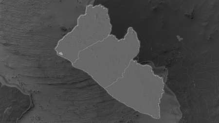 Liberia area enlarged and glowed on a darkened background of its surroundings. Bilevel bumped elevation mapの写真素材