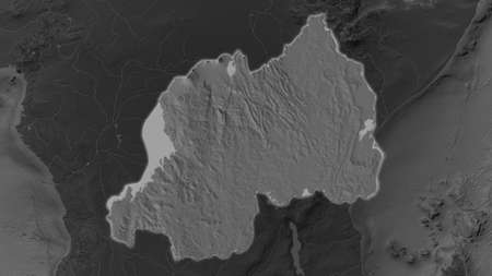 Rwanda area enlarged and glowed on a darkened background of its surroundings. Bilevel bumped...