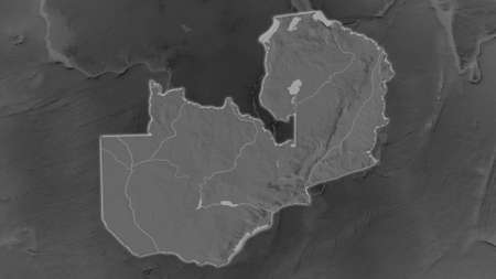 Zambia area enlarged and glowed on a darkened background of its surroundings. Grayscale bumped elevation mapの写真素材