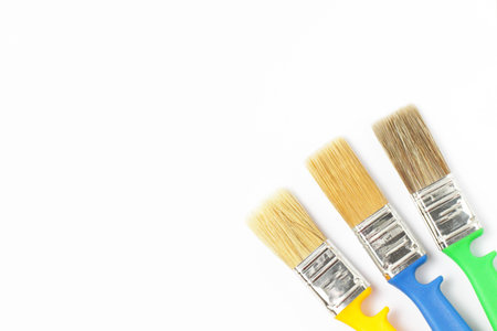Paint brushes of different colors on a white background close-up, flat lay, place for text.の写真素材