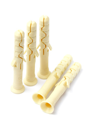 Plastic dowels for interior use, white background, close-up.