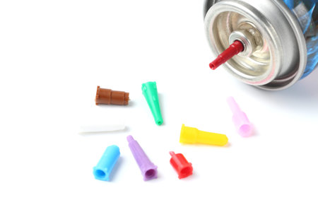 Spray can with gas and different nozzles for charging household burners on a white background,...