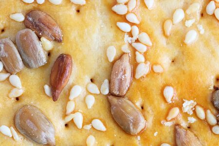 Homemade cookies close-up with sesame seeds and sunflower seeds as a background, top view, flat lay.の写真素材