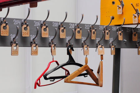 Empty hangers in a school wardrobe waiting for students, close-up. End of quarantine and...