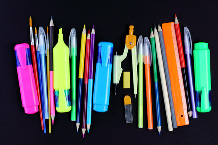 School supplies on black background, pencils, pens, rulers. Back to school or education concept. Top...