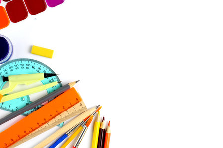 School supplies as a frame on a white background, close-up. Back to school concept. Top view, flat...