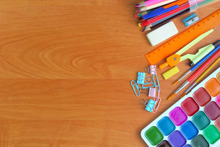 Back to school concept. School supplies as a frame on a writing desk or school desk, close up. Top view, flat lay, place for text, copy space.の写真素材