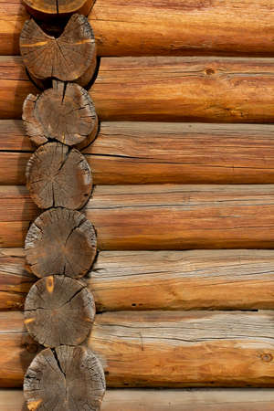 Logs of the wall of an ancient building as a texture or backdrop, vertical frame.の写真素材