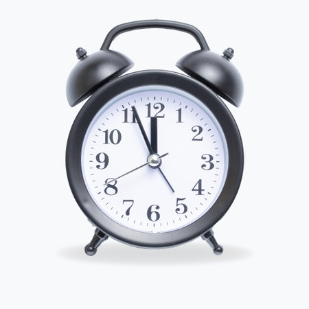 Table alarm clock on a white background isolate, Arabic numerals on the dial, time five minutes...