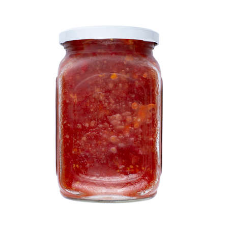 Glass jar with canned mashed tomatoes, isolate without shadow on white. Homemade canned food example.の写真素材