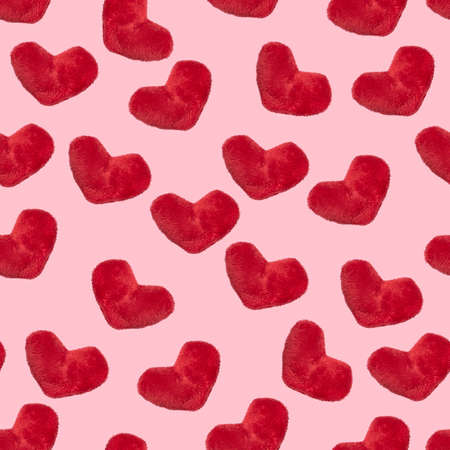 Seamless pattern, plush heart on a pink background, valentine's day or romantic relationship concept.の写真素材