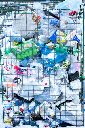 Container with plastic bottles and containers, separate waste collection concept. Krasnoyarsk,...