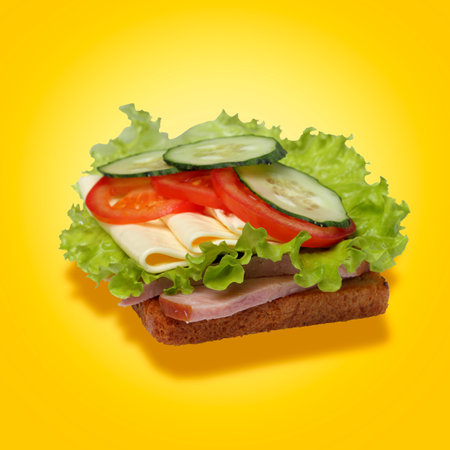 Big sandwich with ham, cheese and vegetables on a yellow background, concept for a fast food banner or flyer, food delivery.の写真素材