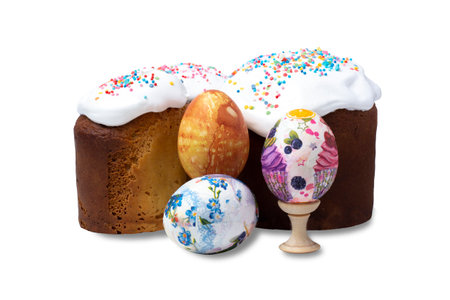 Colorful Easter eggs and Easter tarts with white frosting and sweet caramel on white, isolate. Festive concept.の写真素材