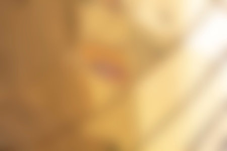 Blurred background of yellow gold tones with a gradient.