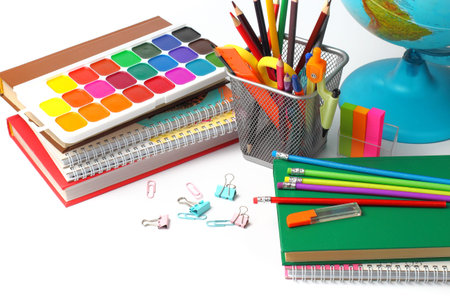 Back to school concept. School supplies on the table, white background. Pencils, pens, rulers,...