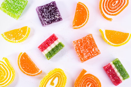 Sweet pattern, marmalade jelly candies of different colors on a white background with sugar...