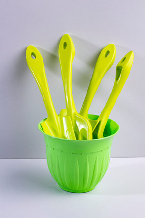 Home gardening tool set in green flower pot.