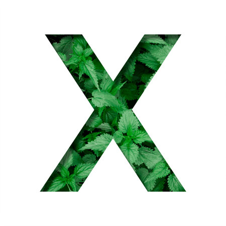 Font made of leaves, letter X, cut out of paper on a background of natural green nettle. Fresh young...
