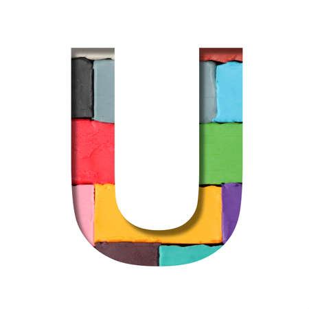Multi-colored plasticine font. Letter U cut out of paper on a background of pieces of colored plasticine. A set of volumetric color fonts.の写真素材
