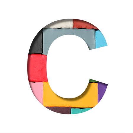 Multi-colored plasticine font. Letter C cut out of paper on a background of pieces of colored plasticine. A set of volumetric color fonts.の写真素材
