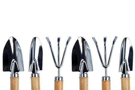 Gardening tools shovels and rakes for home gardening and floriculture on white isolated, copy space.