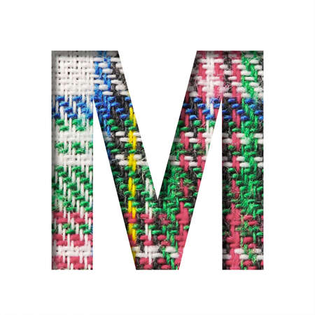 Font on Scottish fabric. The letter M cut out of paper on a textured pattern of real Scottish fabric. Set of decorative fonts.の写真素材