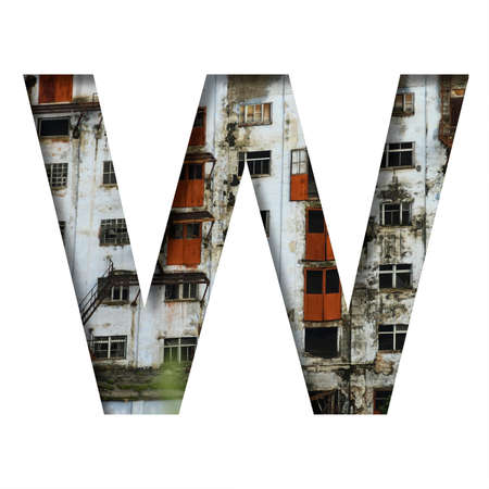 Font on an abandoned industrial building. The letter W cut out of paper on a background of windows and doors of an abandoned industrial building. Set of decorative fonts.の写真素材