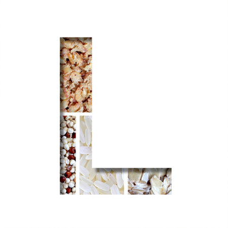 Healthy food font. The letter L is cut from white paper on the background of healthy food from different cereals. Set of decorative fonts with foodの写真素材
