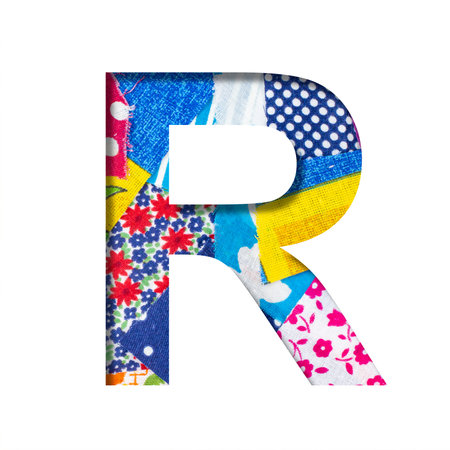 Handicraft or creative font. The letter R cut out of paper on the background of the texture of...