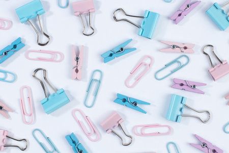 pattern of clothespins and paper clips on white