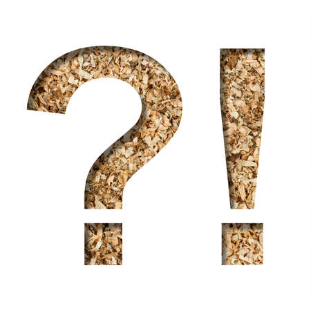 Sawdust wood font. Exclamation and question marks cut out of paper on the background of sawdust of a fruit tree. Decorative alphabet for handmade or small production, font collection.の写真素材