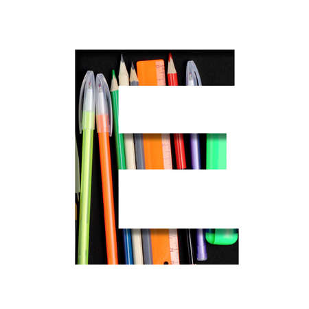 School or office supplies font. The letter E cut out of paper on a background of a set of stationery for school, study or office with black backdrop. Decorative alphabet, font collection.の写真素材