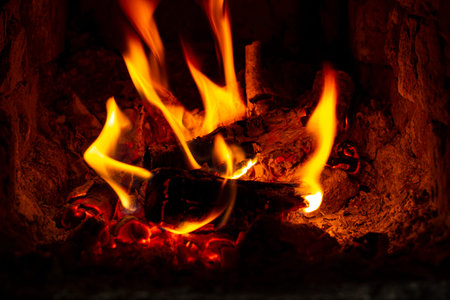 Fire in the fireplace insert or stove close-up.