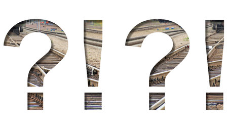 Railway font. Exclamation and question marks is cut out of white paper against the background of...
