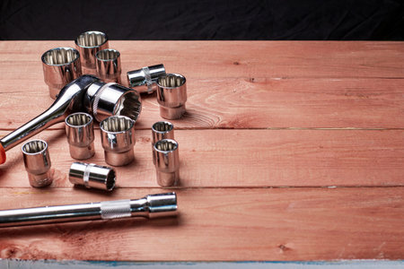 Tool for repairing auto or motorcycle equipment on a wooden table, place for text.