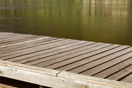 Wooden table or decking on the river bank, close-up.の写真素材