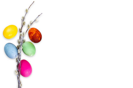 Easter composition, color eggs and spring tree branches on white, top view, close-up, place for...