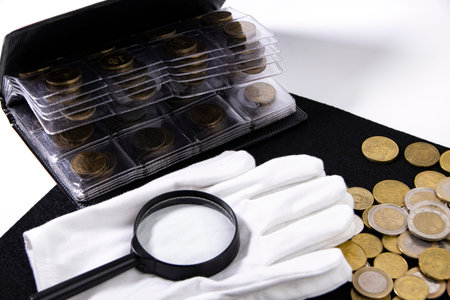 Collection of European coins and collector white gloves on black as background