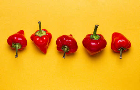 Bright hot habanero peppers on yellow, top view, close-up.の写真素材