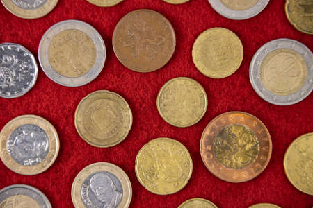 European coins pattern on red cloth close up as a background.の写真素材